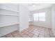 Bedroom with built-in shelving and tile flooring at 5416 Parkway Dr, Belle Isle, FL 32809