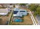 Aerial view showing home with pool, fenced backyard, and solar panels at 5535 Long Lake Dr, Orlando, FL 32810