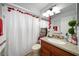 Bright bathroom featuring a white shower curtain and granite vanity at 5535 Long Lake Dr, Orlando, FL 32810