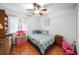 Comfortable bedroom with ceiling fan and hardwood floors at 5535 Long Lake Dr, Orlando, FL 32810