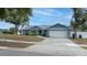 Charming light blue house with a white garage door at 5535 Long Lake Dr, Orlando, FL 32810