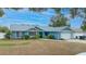 Cute light blue house with a white garage door at 5535 Long Lake Dr, Orlando, FL 32810