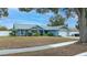 Light blue house with a white garage and large tree at 5535 Long Lake Dr, Orlando, FL 32810