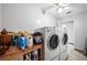 Laundry room with washer, dryer, and built-in storage at 5535 Long Lake Dr, Orlando, FL 32810