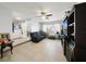 Living room features dark gray couch, built in shelving, and a large TV at 5535 Long Lake Dr, Orlando, FL 32810