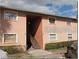 Tan colored two-story building with stairs leading to the entrance at 5885 Dahlia Dr # 24, Orlando, FL 32807