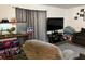 Inviting living room with a plush recliner, TV, and a gray color scheme at 5885 Dahlia Dr # 24, Orlando, FL 32807