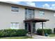 A two-story apartment building with a covered entrance and manicured landscaping offers a welcoming curb appeal at 5885 Dahlia Dr # 31/116, Orlando, FL 32807