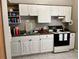 Efficient kitchen with white cabinetry and black appliances at 5885 Dahlia Dr # 31/116, Orlando, FL 32807