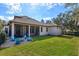 Expansive backyard featuring a well-maintained lawn, covered patio, and comfortable outdoor seating at 6874 Valhalla Way, Windermere, FL 34786