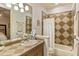 Bathroom with tiled countertop, white shower curtain, and a large mirror at 6874 Valhalla Way, Windermere, FL 34786