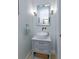 Stylish powder room features a vessel sink, chrome fixtures, and a decorative mirror at 6874 Valhalla Way, Windermere, FL 34786