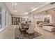 Elegant dining area with a large wooden table, chandelier lighting, and seamless access to other living spaces at 6874 Valhalla Way, Windermere, FL 34786