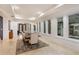 Dining room with coffered ceiling and seamless access to the outdoor space at 6874 Valhalla Way, Windermere, FL 34786