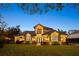 Stunning two-story home with manicured lawn and beautifully lit exterior at 6874 Valhalla Way, Windermere, FL 34786