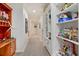 Hallway with built-in shelving and storage for toys and collectibles at 6874 Valhalla Way, Windermere, FL 34786