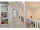 Upstairs hallway with built-in storage and carpet flooring at 6874 Valhalla Way, Windermere, FL 34786