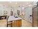 Bright and airy kitchen featuring a large island, updated cabinets, and travertine flooring at 6874 Valhalla Way, Windermere, FL 34786