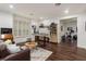 Cozy living room with hardwood floors, custom desk and shelving, and comfortable seating ideal for relaxation at 6874 Valhalla Way, Windermere, FL 34786