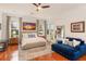 Bright main bedroom featuring hardwood floors, large windows, and a cozy seating area perfect for relaxation at 6874 Valhalla Way, Windermere, FL 34786