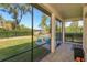 Spacious screened porch overlooking a lush green yard, perfect for outdoor relaxation and entertainment at 6874 Valhalla Way, Windermere, FL 34786