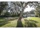 Large backyard with fire pit, pergola and large tree at 7007 Seminole Dr, Belle Isle, FL 32812