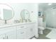 Elegant bathroom with double vanity, large mirrors, and a walk-in shower at 7007 Seminole Dr, Belle Isle, FL 32812