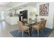 Modern dining area with glass table, wicker chairs, and stylish rug at 7007 Seminole Dr, Belle Isle, FL 32812