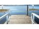 Wooden dock with metal railings extending over calm lake water at 7007 Seminole Dr, Belle Isle, FL 32812