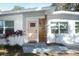 Renovated entryway with pink door and wood paneling at 7007 Seminole Dr, Belle Isle, FL 32812