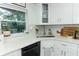 Kitchen corner with sink, dishwasher, and white cabinets at 7007 Seminole Dr, Belle Isle, FL 32812