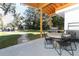 Outdoor patio with dining table and grill, overlooking the yard at 7007 Seminole Dr, Belle Isle, FL 32812