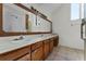 Bathroom with dual sinks and large mirror at 7025 Hiawassee Oak Dr, Orlando, FL 32818