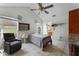 Cozy bedroom with a striped bedspread and ceiling fan at 7025 Hiawassee Oak Dr, Orlando, FL 32818