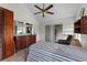 Spacious bedroom with a large dresser and ceiling fan at 7025 Hiawassee Oak Dr, Orlando, FL 32818