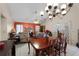 Dining area adjacent to living room with a wood table at 7025 Hiawassee Oak Dr, Orlando, FL 32818