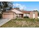 One-story house with attached garage and manicured lawn at 7025 Hiawassee Oak Dr, Orlando, FL 32818