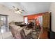 Living room with fireplace and brown leather couches at 7025 Hiawassee Oak Dr, Orlando, FL 32818