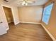 Bedroom features wood-look floors, a ceiling fan, and a walk-in closet for ample storage at 731 Sugar Bay Way # 103, Lake Mary, FL 32746