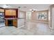 Open living area with tile floors and kitchen access at 731 Sugar Bay Way # 103, Lake Mary, FL 32746