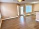 Bright living room featuring wood-look flooring and a ceiling fan for comfortable living at 731 Sugar Bay Way # 103, Lake Mary, FL 32746