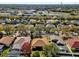 Residential neighborhood with houses featuring various roof styles and landscaping at 7895 Saint Giles Pl, Orlando, FL 32835