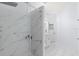 Bathroom featuring frameless shower, marble surround, white cabinets, and modern finishes at 7895 Saint Giles Pl, Orlando, FL 32835