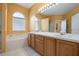 Bright bathroom boasts double sinks, a large mirror, and a garden tub at 7895 Saint Giles Pl, Orlando, FL 32835