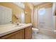 Bathroom with tub, sink, and octagonal window at 7895 Saint Giles Pl, Orlando, FL 32835