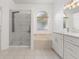 Bathroom featuring double vanity, garden tub, separate shower, and modern finishes at 7895 Saint Giles Pl, Orlando, FL 32835