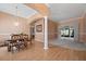 Dining area with hardwood floors, neutral walls, and access to the Gathering room at 7895 Saint Giles Pl, Orlando, FL 32835