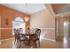 Dining room with hardwood floors, neutral walls, and a formal dining table set at 7895 Saint Giles Pl, Orlando, FL 32835