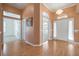 Bright entryway with hardwood floors, neutral walls, and access to other rooms at 7895 Saint Giles Pl, Orlando, FL 32835