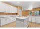 Bright kitchen with white cabinetry, stainless steel appliances, and a center island with stone countertops at 7895 Saint Giles Pl, Orlando, FL 32835